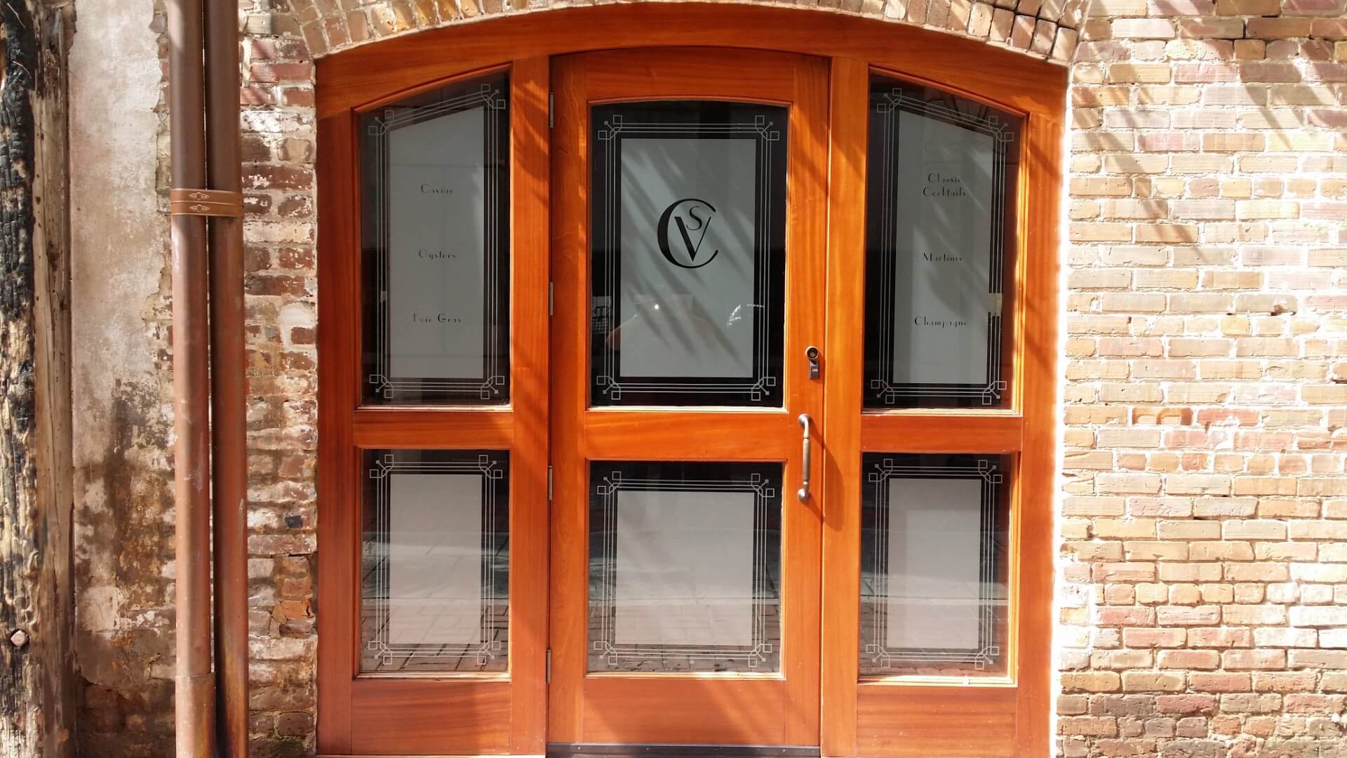 Storefront with custom wood doors and millwork in Charleston by MW Millworks